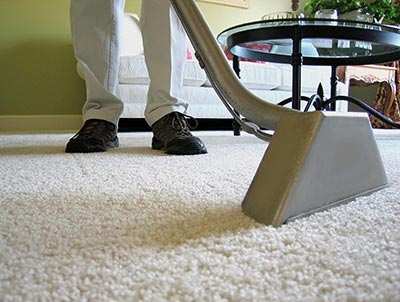 A man while giving carpet cleaning service in an office